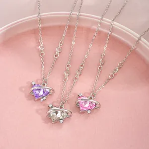 Macro detail of heart-shaped planet pendants in purple, pink and white with silver chain