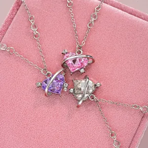 Three heart planet necklaces with purple and pink crystals in a velvet gift box