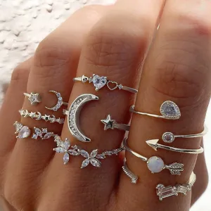 Macro view of 11-piece silver stackable ring set with moon, star, and heart zircon details