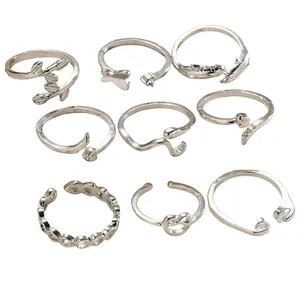 9-piece set of silver adjustable open rings with leaf, heart, and dolphin designs