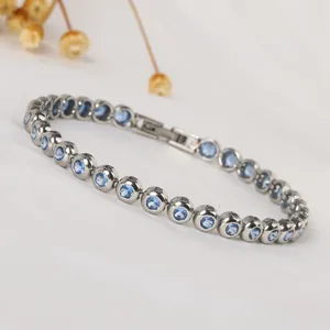 Detail view of silver titanium steel bracelet with bezel-set light blue round zircons