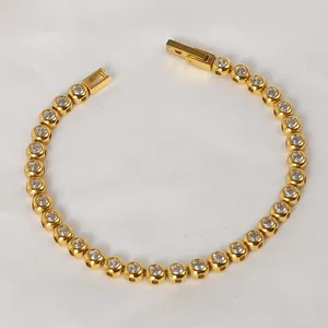 Macro detail of golden titanium steel tennis bracelet with round clear zirconia stones