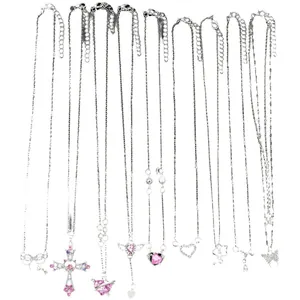 9-piece silver necklace set featuring cross, bow, and heart pendants with pink crystals