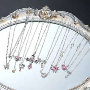 Set of silver Y2K necklaces with rhinestone butterfly heart and cross pendants