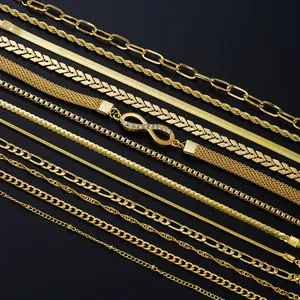 Detailed assortment of 14 gold chains including Figaro and infinity pavé styles