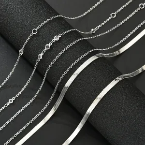 Double-layered silver snake chain body necklace with cross tassel and sparkling rhinestones