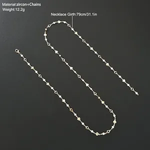 Long lariat Y necklace with hollow heart links and zircon crystal tassels in gold finish