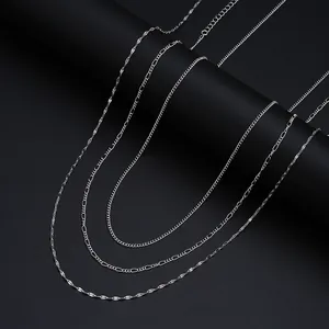 Three-piece set of elegant silver sequin chain belts for women on a dark background