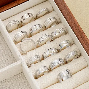 Close-up of 16-piece silver toe ring set with star and heart designs in jewelry box