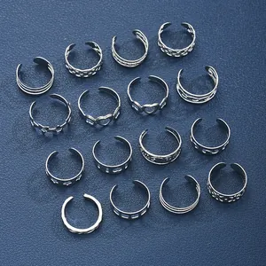 Macro shot of 16-piece silver toe ring set featuring heart and leaf cutout designs