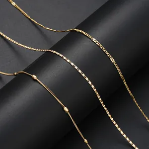 Detail of three types of gold-plated chains including bead, flat link, and box chain styles