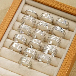 Macro shot of 14-piece silver ring set with heart and star patterns in jewelry box