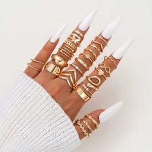 Close-up of 25-piece gold butterfly and heart stacking rings worn on model fingers