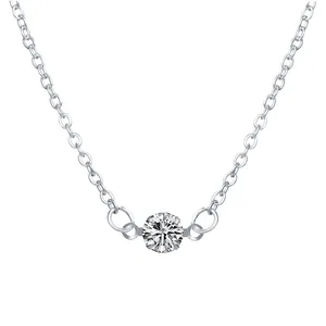 Detail showing a minimalist silver necklace with a brilliant round-cut zirconia pendant