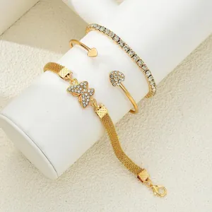 Set de pulseras doradas multicapa con dijes de corazón y mariposa con diamantes finos
