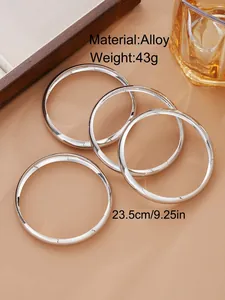 Detailed view of silver alloy bracelet set with polished finish on leather surface
