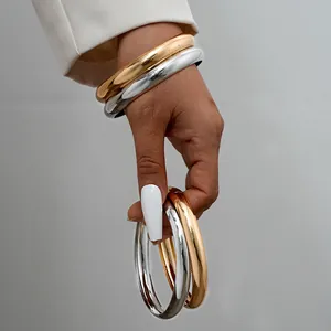 Fashionable chunky metal bangle set in gold and silver finish for women style