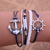 Bracelet multicouche nautique avec breloques ancre et gouvernail sur fond journal rétro