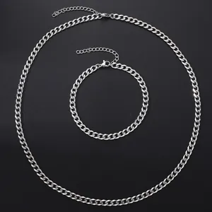 Silver Cuban link necklace and bracelet set with lobster clasp on black background