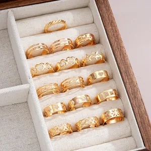 Detail view of a 17-piece gold hollow star and heart toe ring set in a wooden jewelry box