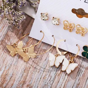 Chic 6-pair gold earring set featuring butterfly, heart motifs, and clear rhinestones