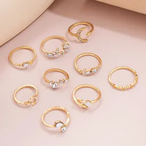 9-piece gold celestial ring set featuring moon, star, heart, and crystal accents
