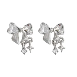 Elegant silver bow stud earrings with sparkling zircon crystals and hanging star charms
