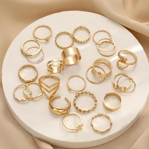 Detailed set of 25 gold boho rings with stars, moons and snakes on a marble display