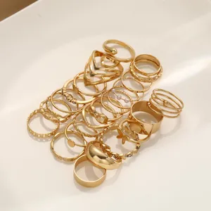 25-piece gold stackable ring set with moon, star, snake, and butterfly designs