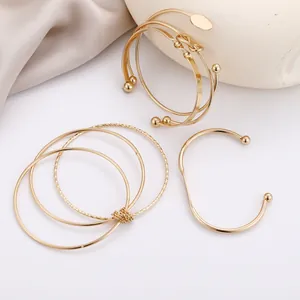 Five-piece set of geometric gold plated minimalist knot and twist open bangles for women