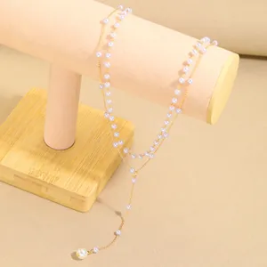 Double-layered gold Y-necklace featuring elegant faux pearl fringe and layered styling