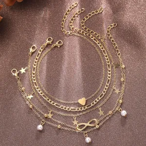 Detailansicht des 5-teiligen Gold-Fußkettchen-Sets mit Stern, Herz, Unendlichkeit und Perlen