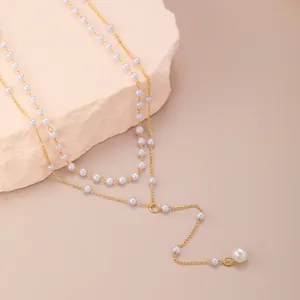 Double-layered golden Y-necklace featuring elegant white pearls and delicate long tassels