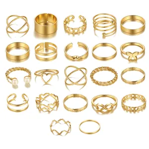 Detail of 22-piece gold ring set featuring butterfly motifs and faux pearls