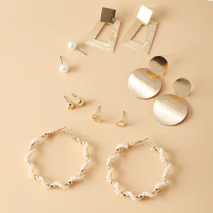 Close-up of 6-pair gold alloy earring set featuring faux pearls and geometric shapes
