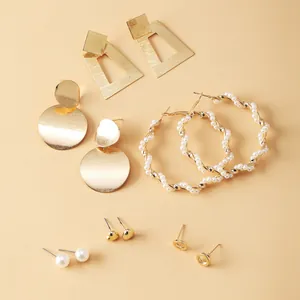 Detail of 5-piece earring set with gold geometric shapes, hoops, and faux pearls