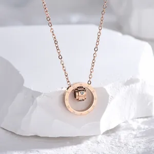 Rose gold necklace with Roman numerals and embedded crystals on a double ring pendant