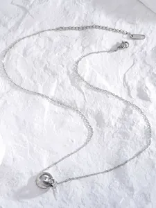 Vue détaillée du collier argenté à chiffres romains et anneaux sertis de zircons