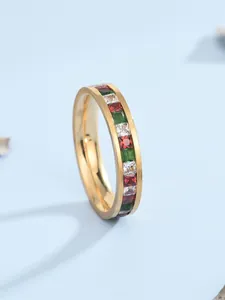 Vue macro d'une bague en acier doré sertie de zircons carrés colorés arc-en-ciel