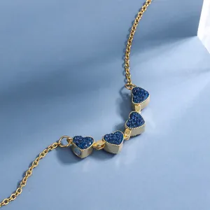 Collana a cuore pieghevole dorata con intarsi blu trasformabile in quadrifoglio