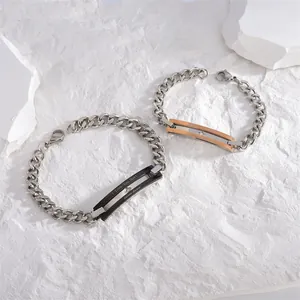 Macro shot of titanium steel couple bracelets with zircon stones and engraved text
