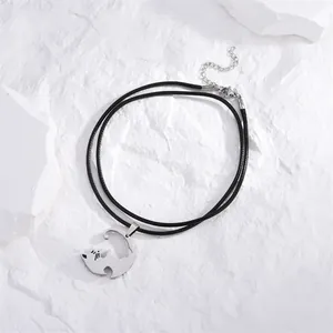 Minimalist silver cat necklace with black cord on white stone, stainless steel couple gift