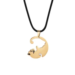 Gold cat pendant necklace with black cord, sleek hollow metal design on white background