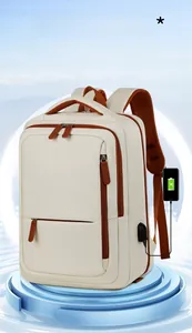 Detail view of the side USB charging port on the cream and brown travel backpack