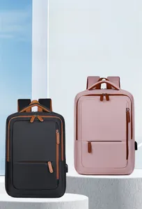 Detail of travel backpack showing USB charging port and durable nylon fabric in pink and black