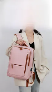 Pink travel backpack featuring dual zipper pockets and an external USB charging port