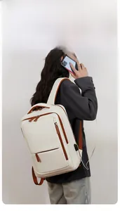 Side view of white and brown travel backpack with built-in USB charging port for laptops