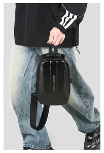 Detail of black hard shell crossbody bag featuring carbon fiber texture and secure TSA lock