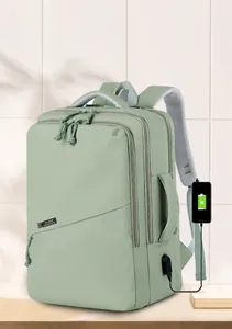 Close-up of mint green laptop backpack featuring external USB charging port and water-resistant fabric