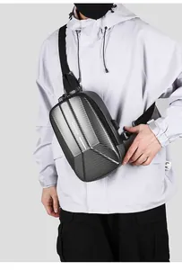 Detail of hard shell crossbody bag with carbon fiber texture and built-in USB charging port